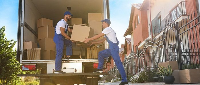 Workers Unloading Boxes From Van Outdoors. Moving Service Professional Movers- Pick n Move NYC
